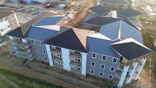 An aerial view of a large apartment building under construction.