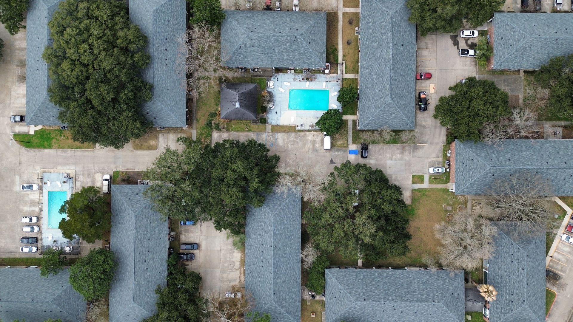 An aerial view of a residential area with lots of buildings and trees.