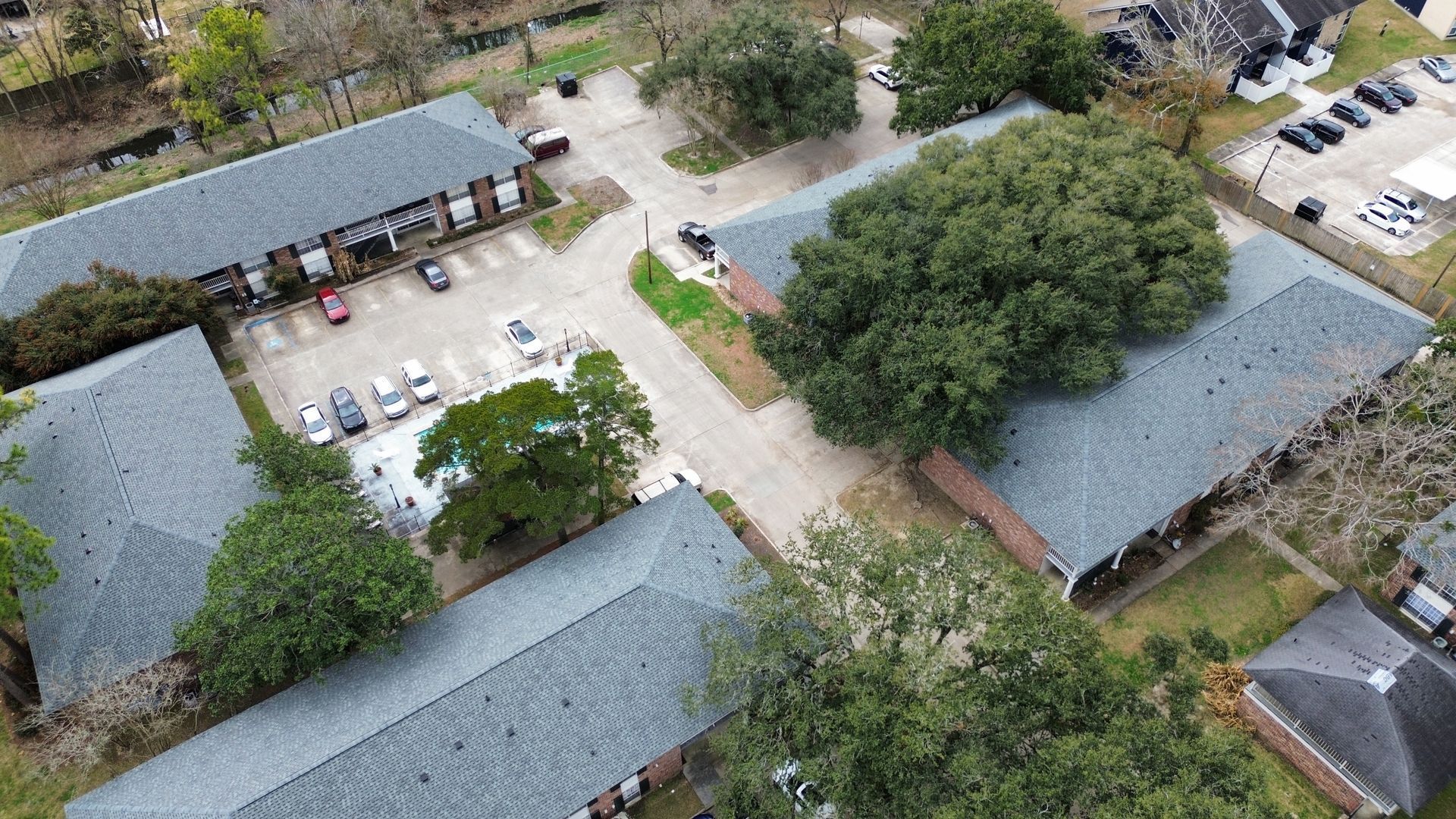 An aerial view of a residential area with lots of buildings and trees.