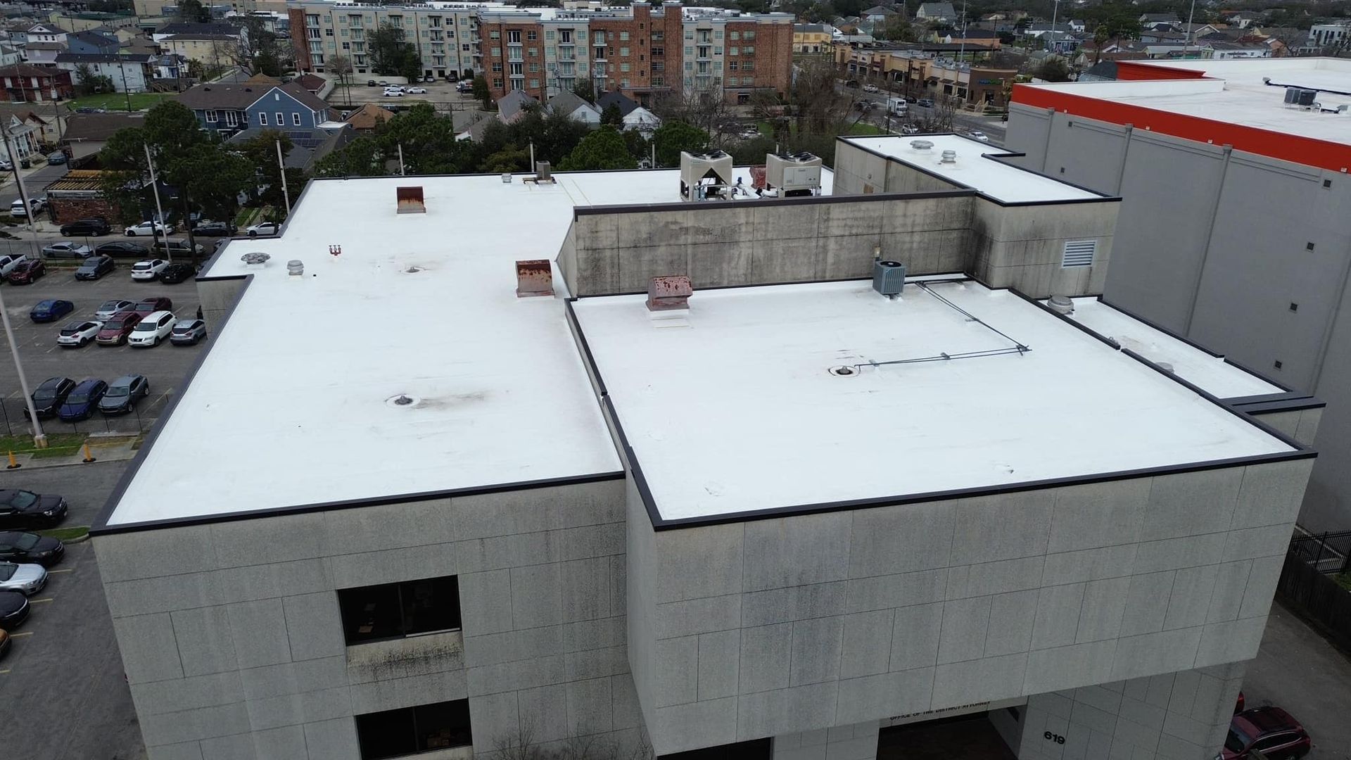 An aerial view of a building with a white roof.