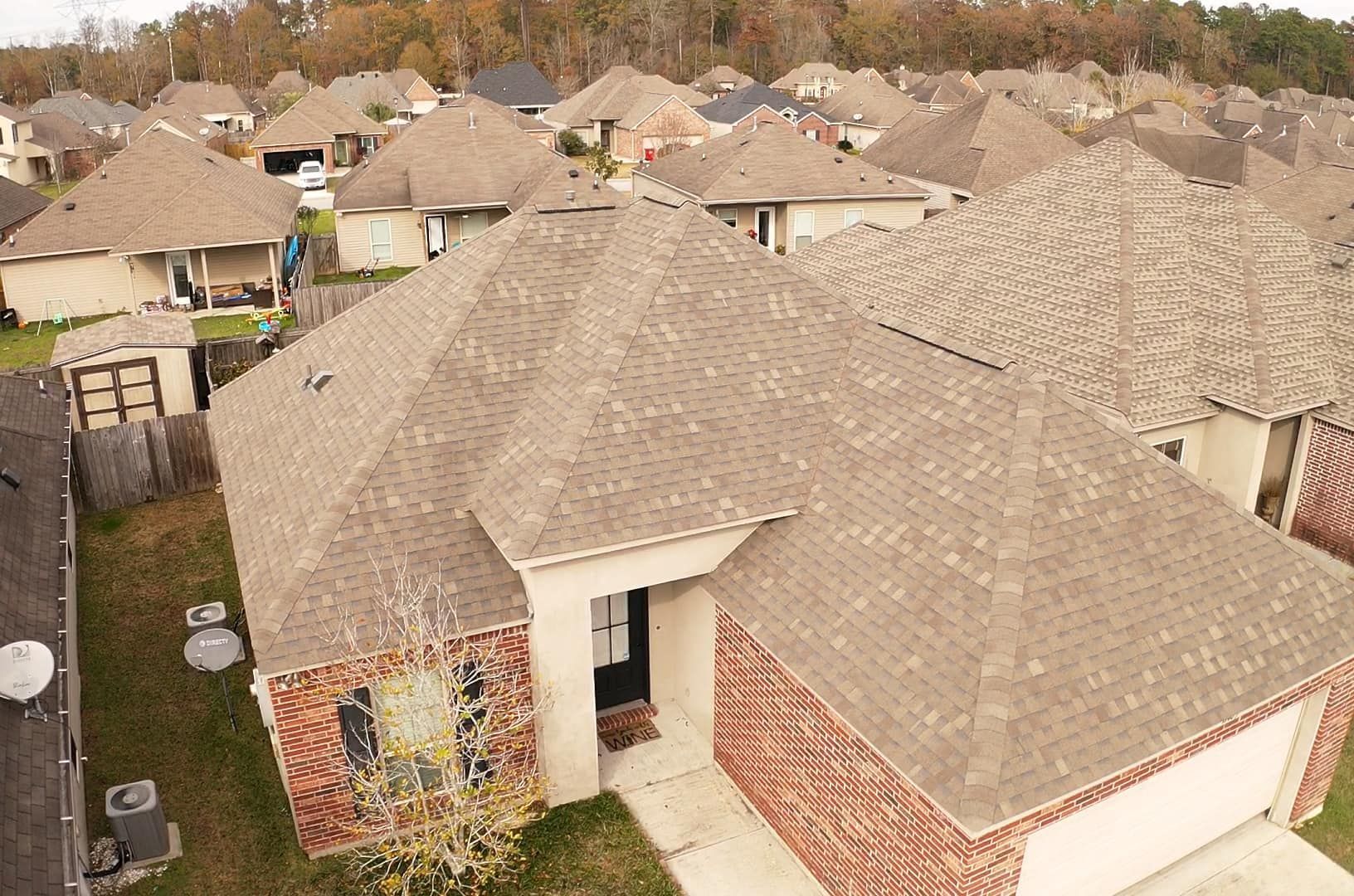 An aerial view of a residential area with a lot of houses and roofs