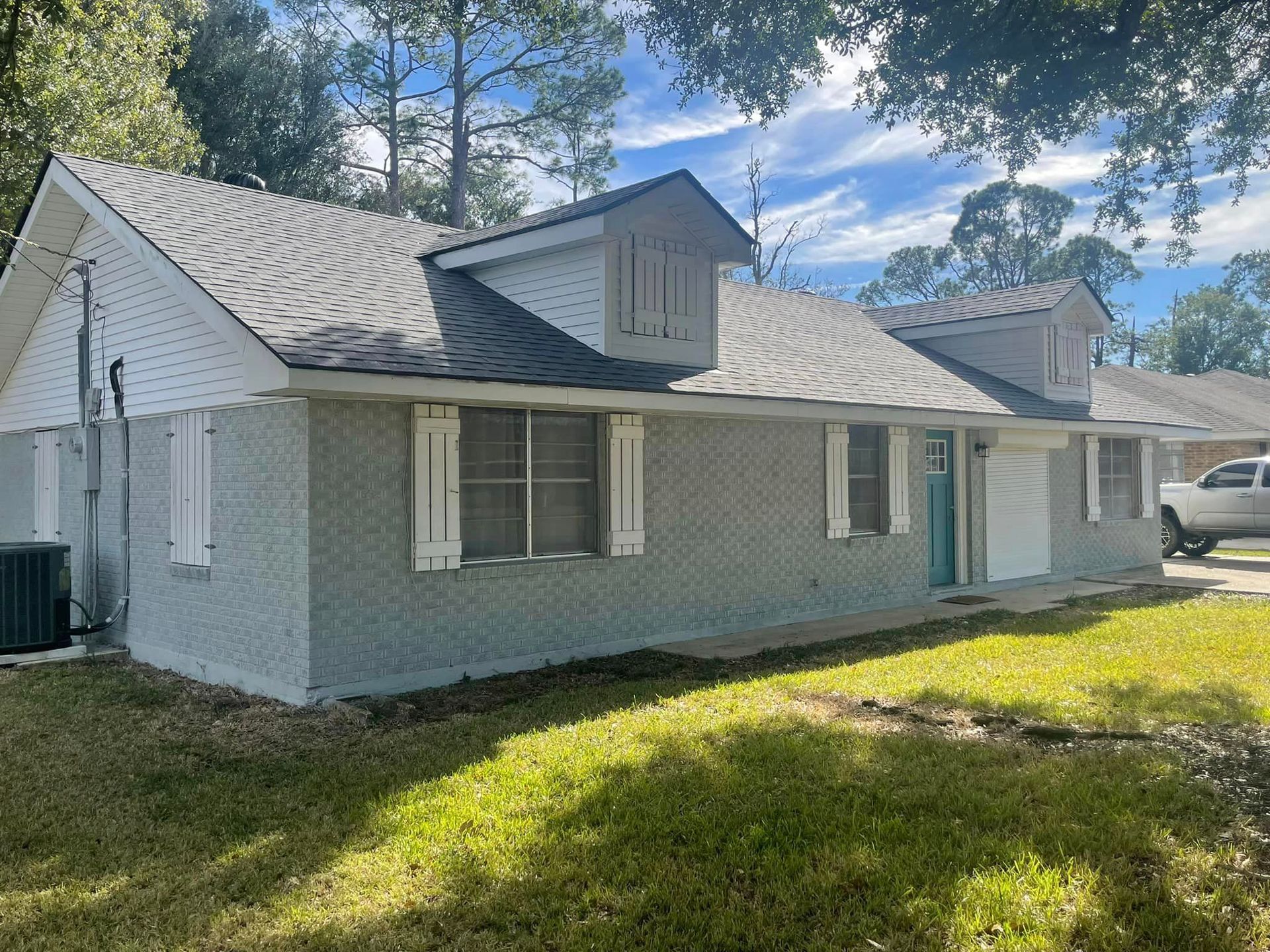 A house with a white truck parked in front of it