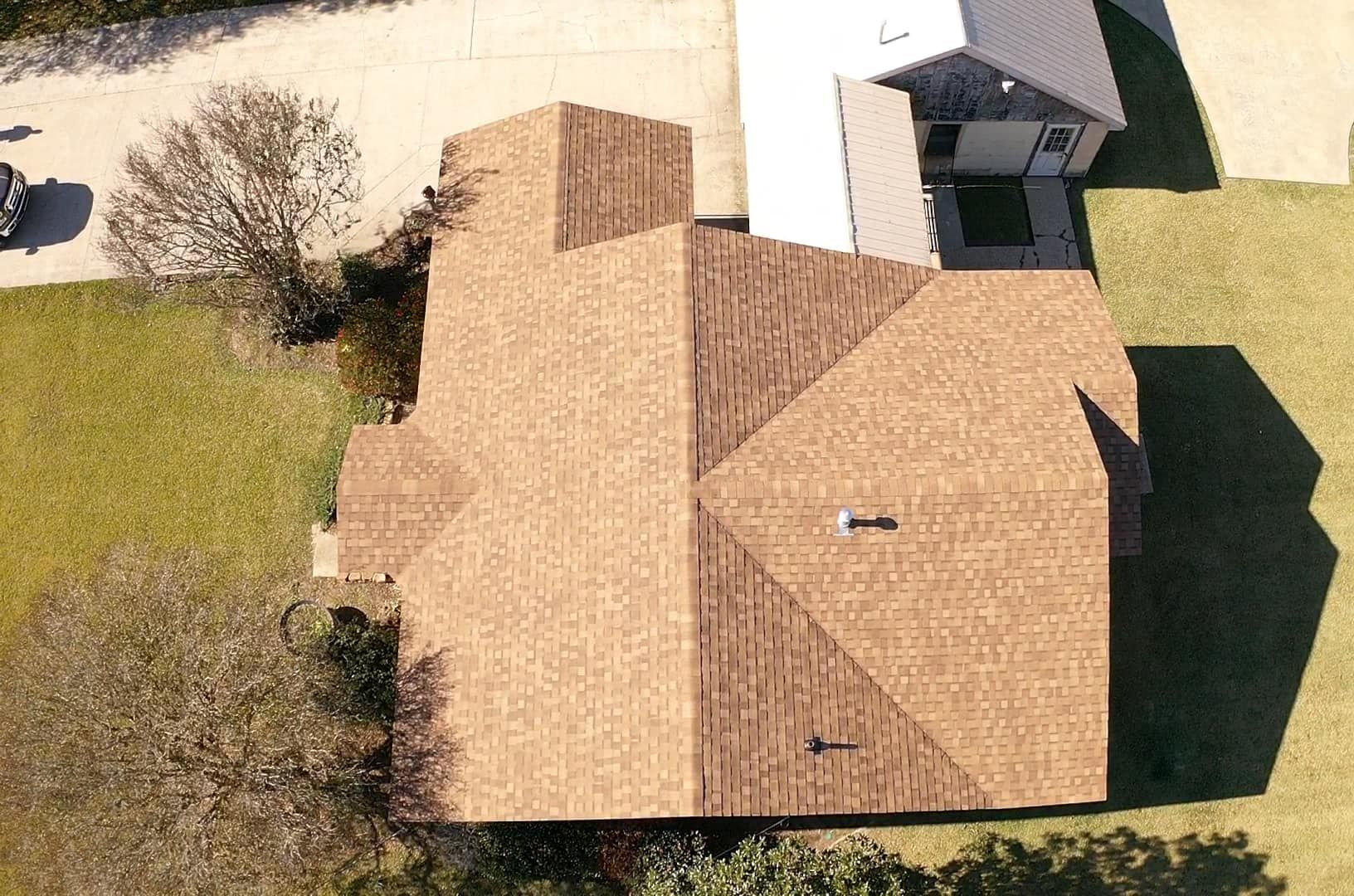An aerial view of a house with a brown roof