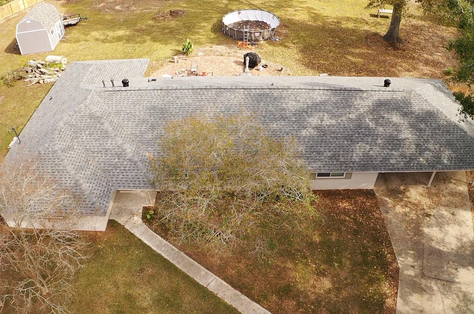 An aerial view of a house with a roof that is being repaired