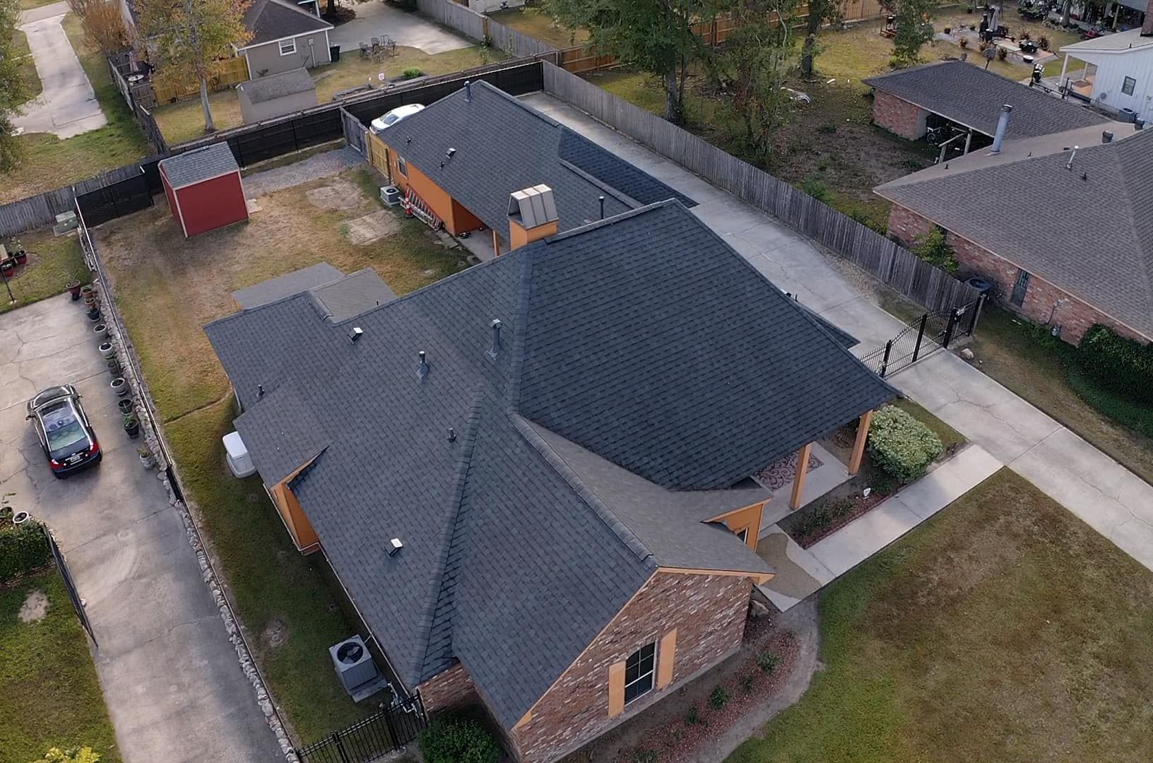 An aerial view of a house with a black roof