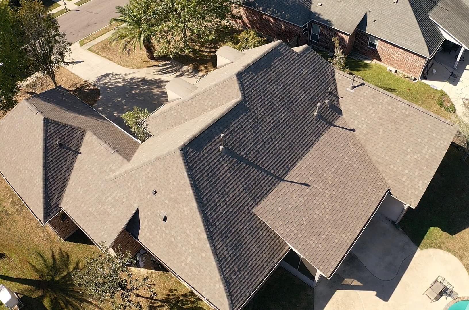 An aerial view of a house with a large roof