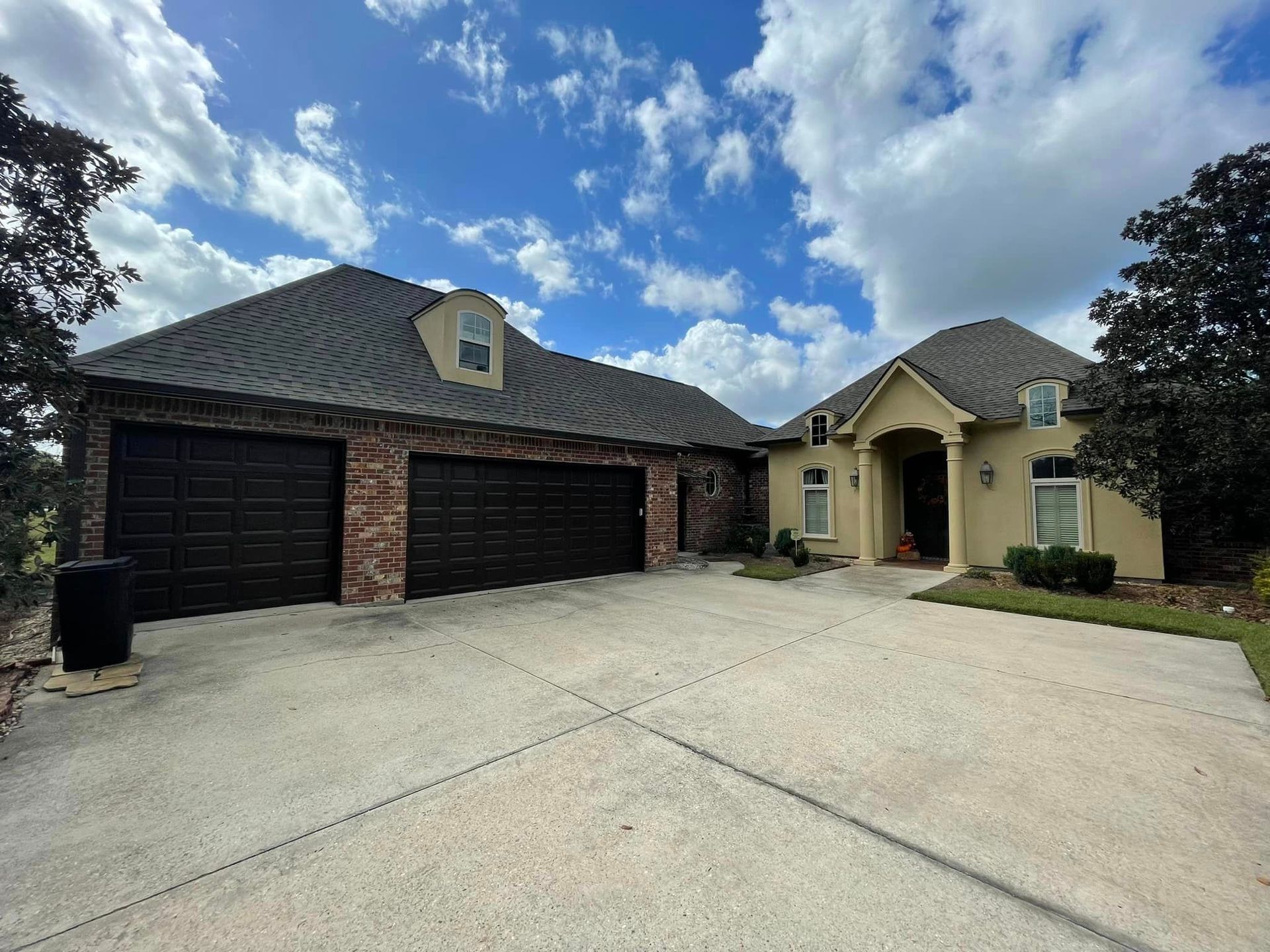 A large house with a lot of garage doors and a driveway