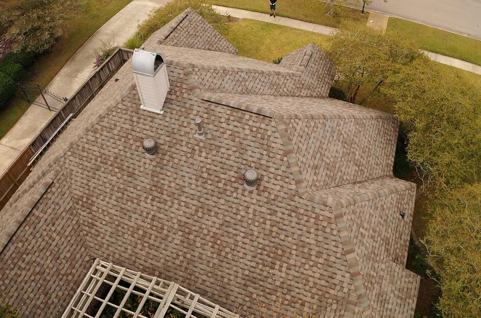 An aerial view of a roof of a house with a chimney