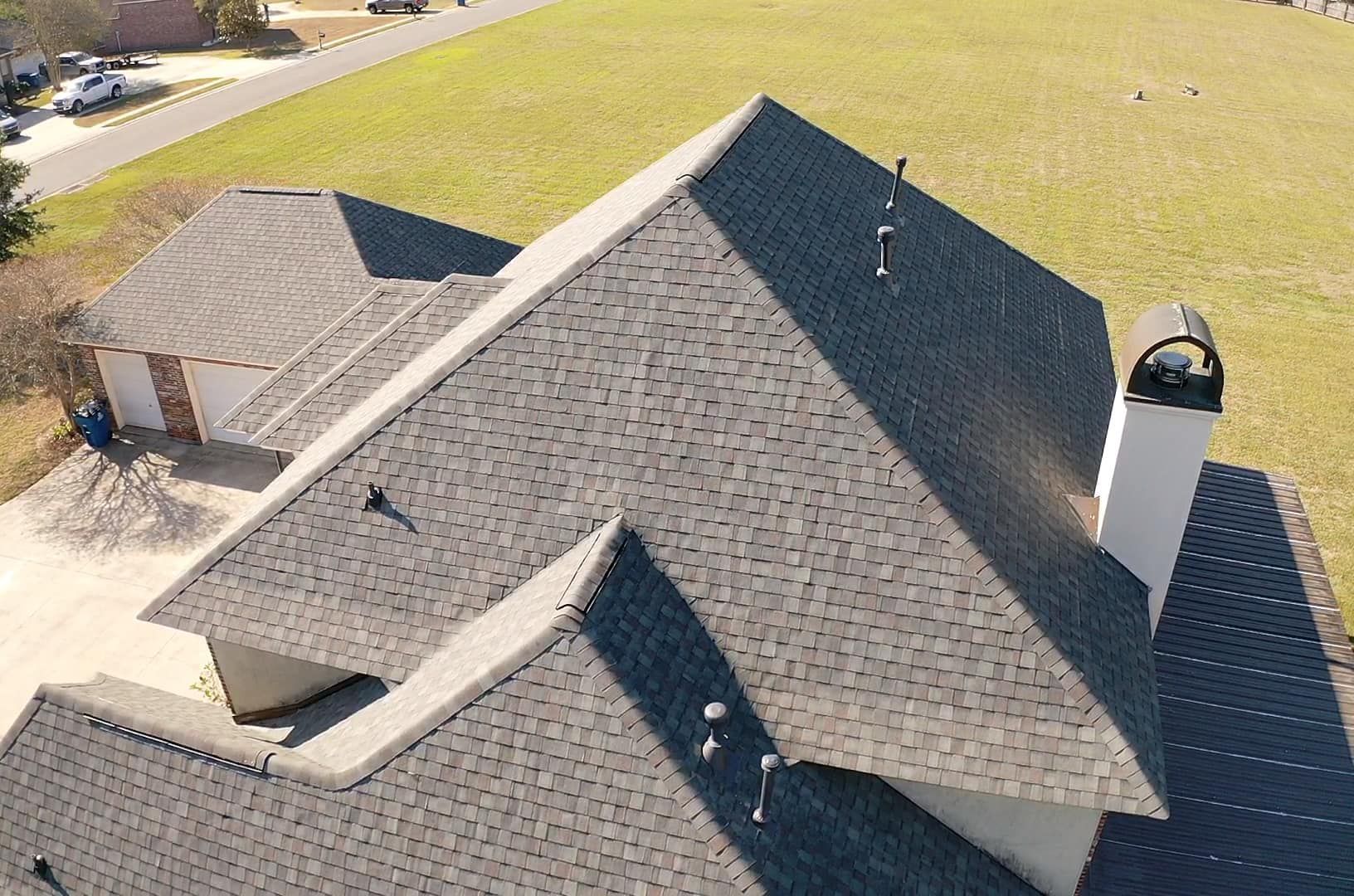 An aerial view of a house with a roof and a chimney