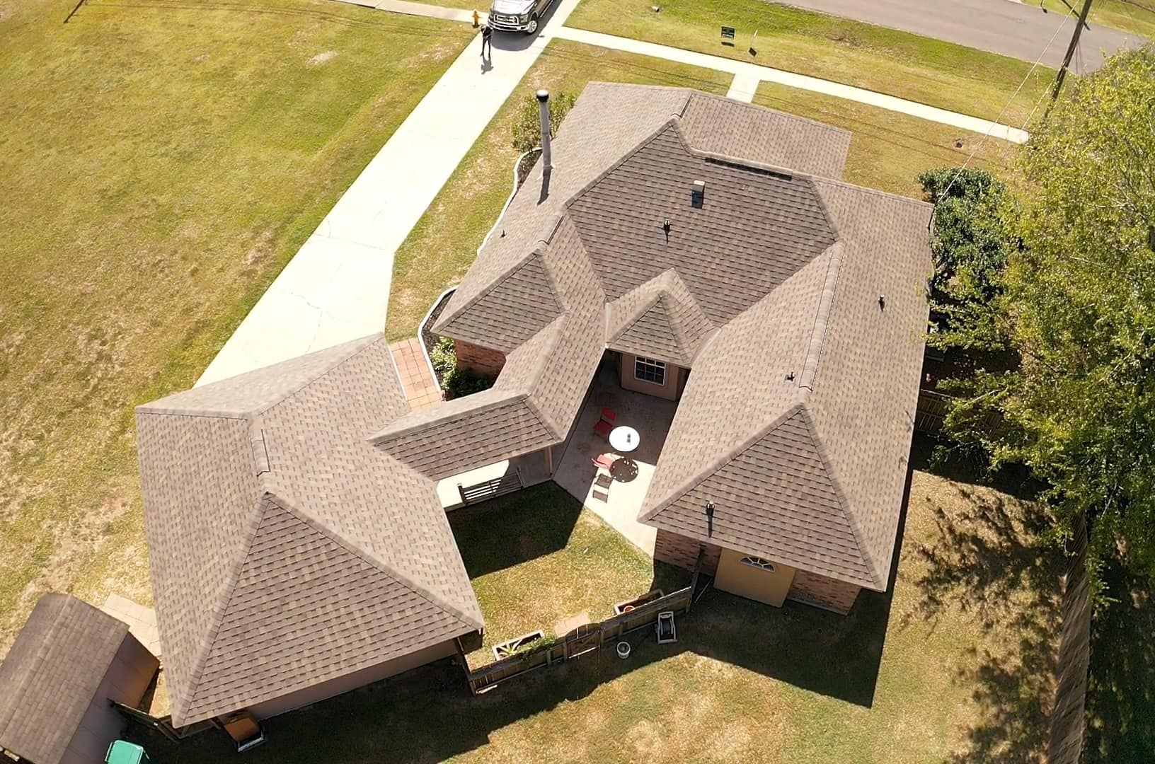 an aerial view of a house with a large roof