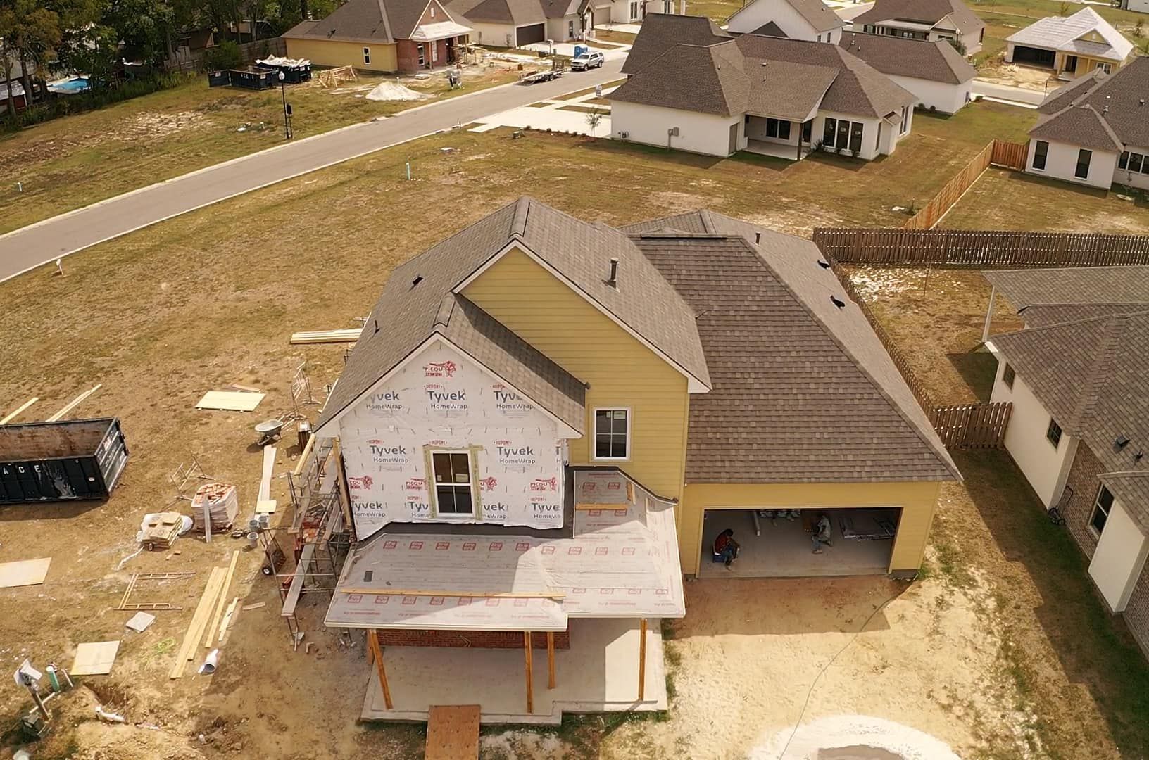 An aerial view of a house under construction in a residential area