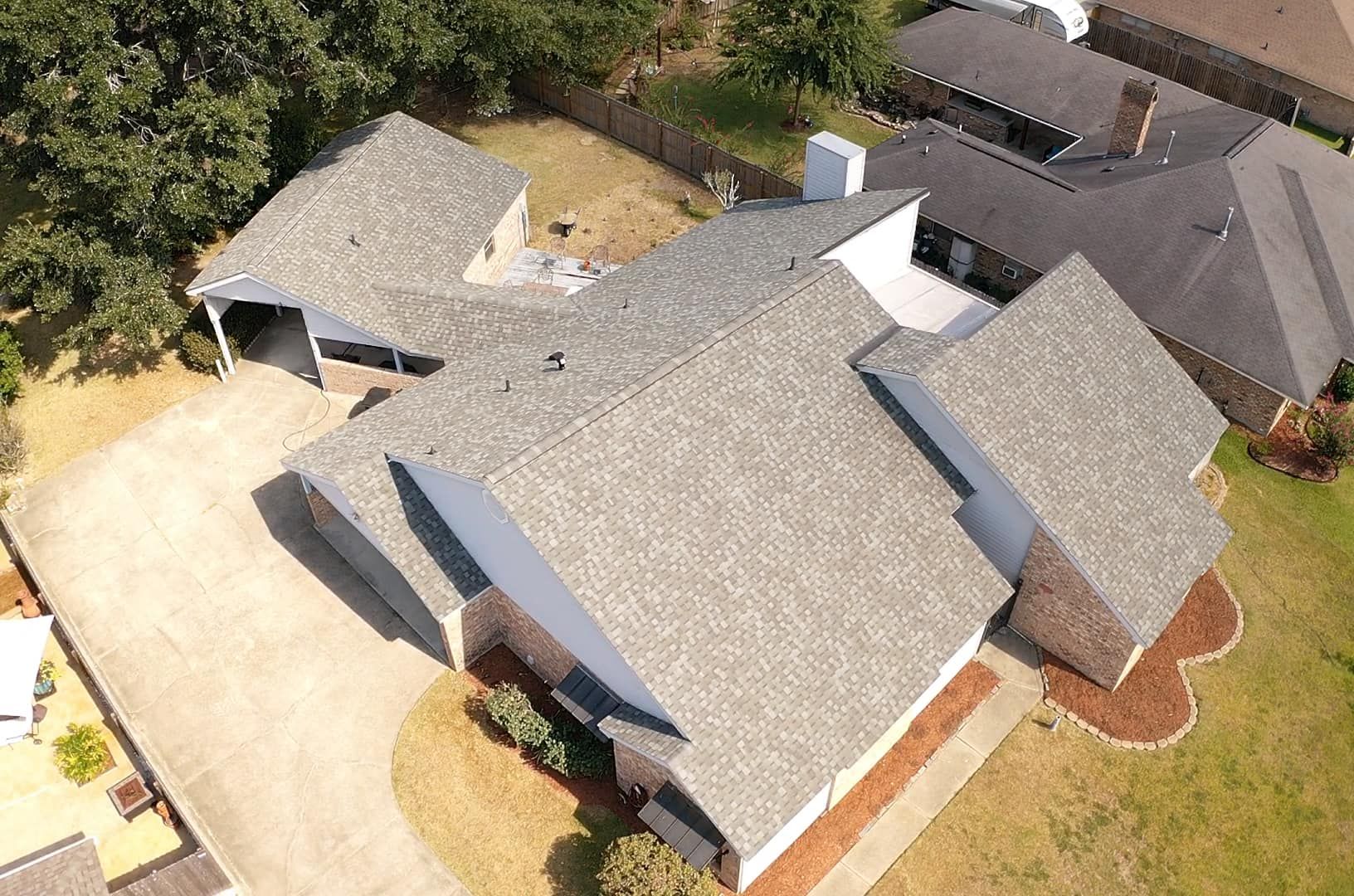 An aerial view of a house with a gray roof