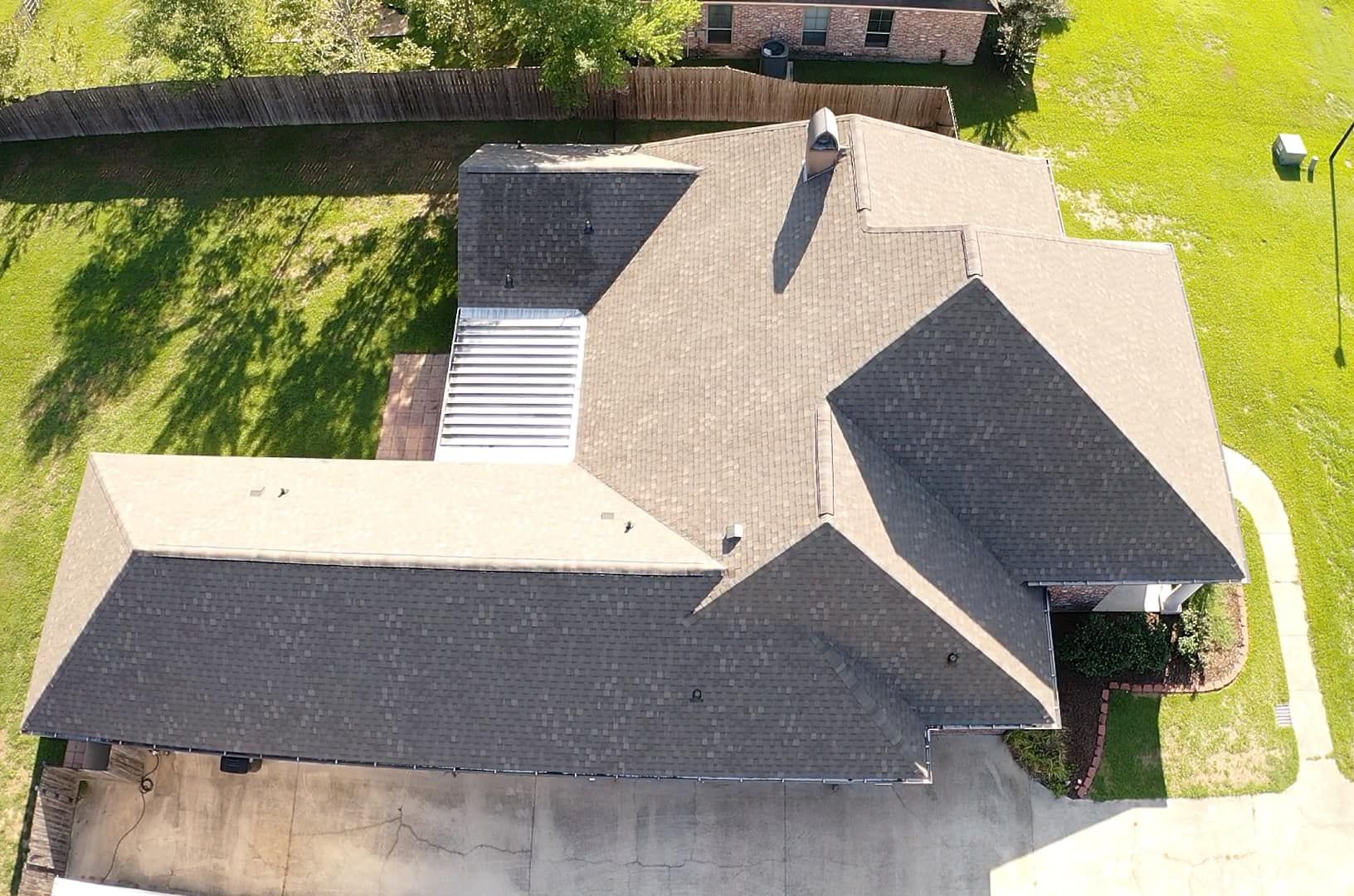 An aerial view of a house with a large roof