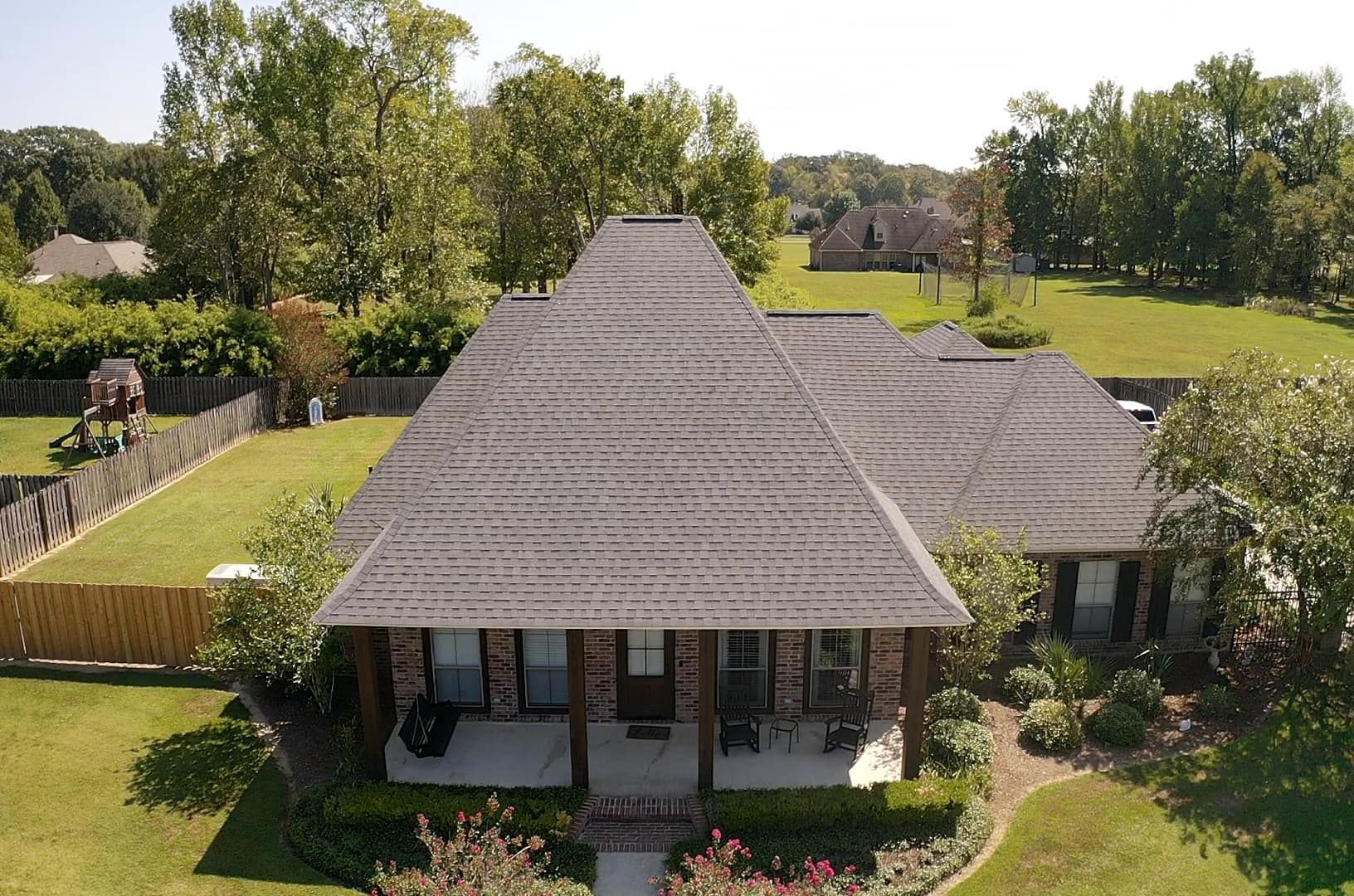 An aerial view of a house with a large roof
