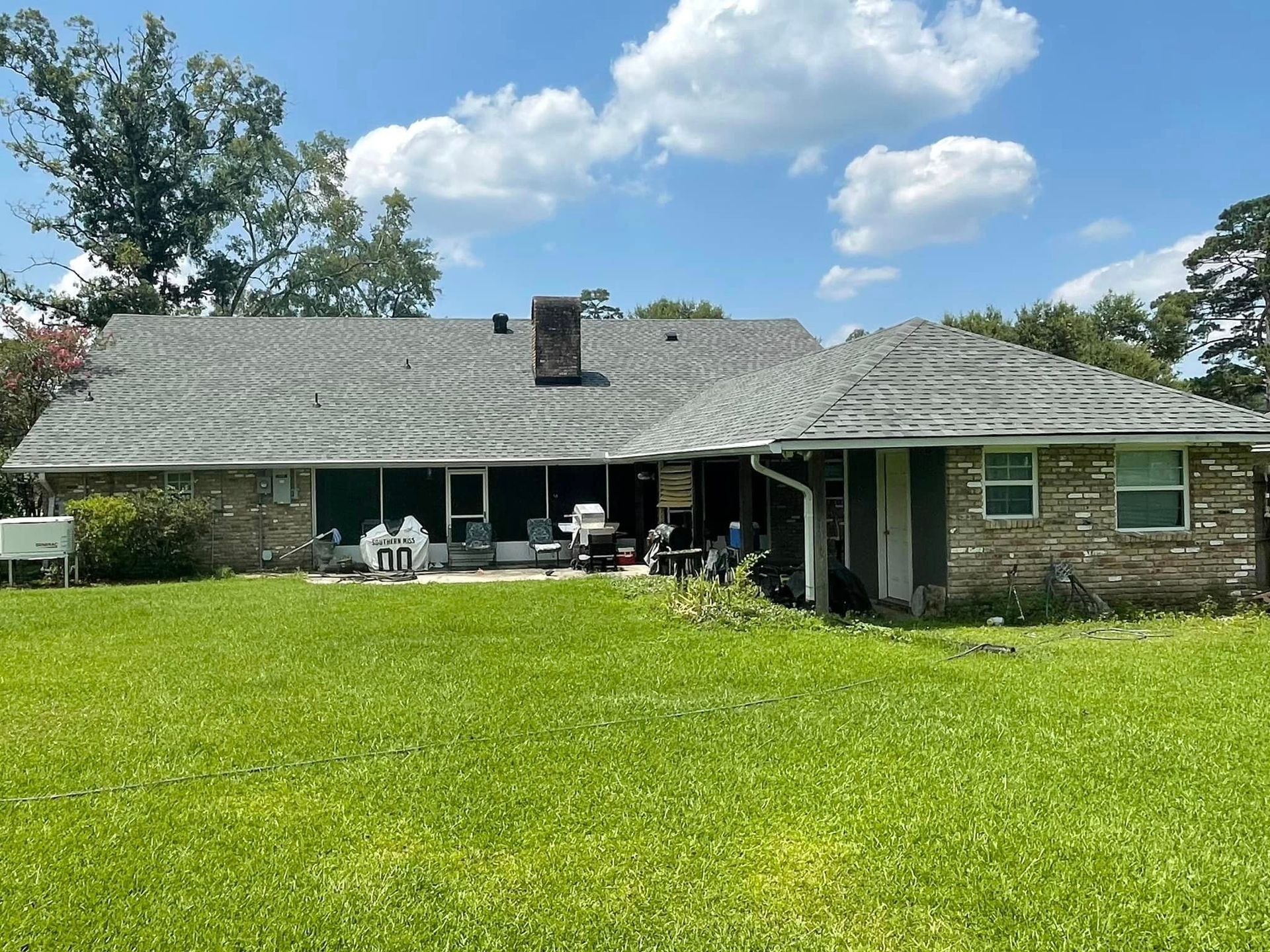 The back of a house with a large lawn in front of it