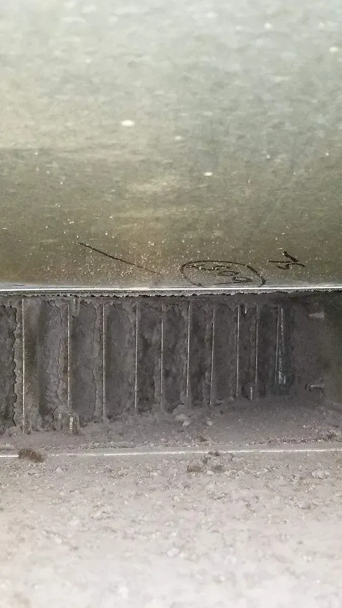 Air vent with dust and dirt accumulation.