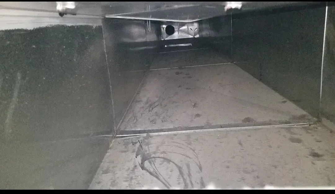 Inside view of an empty, rectangular HVAC duct made of silver metal.