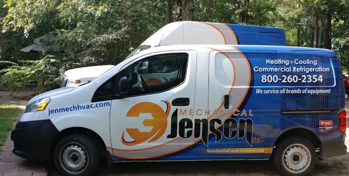Blue and white utility van with heating and cooling company branding parked outdoors.