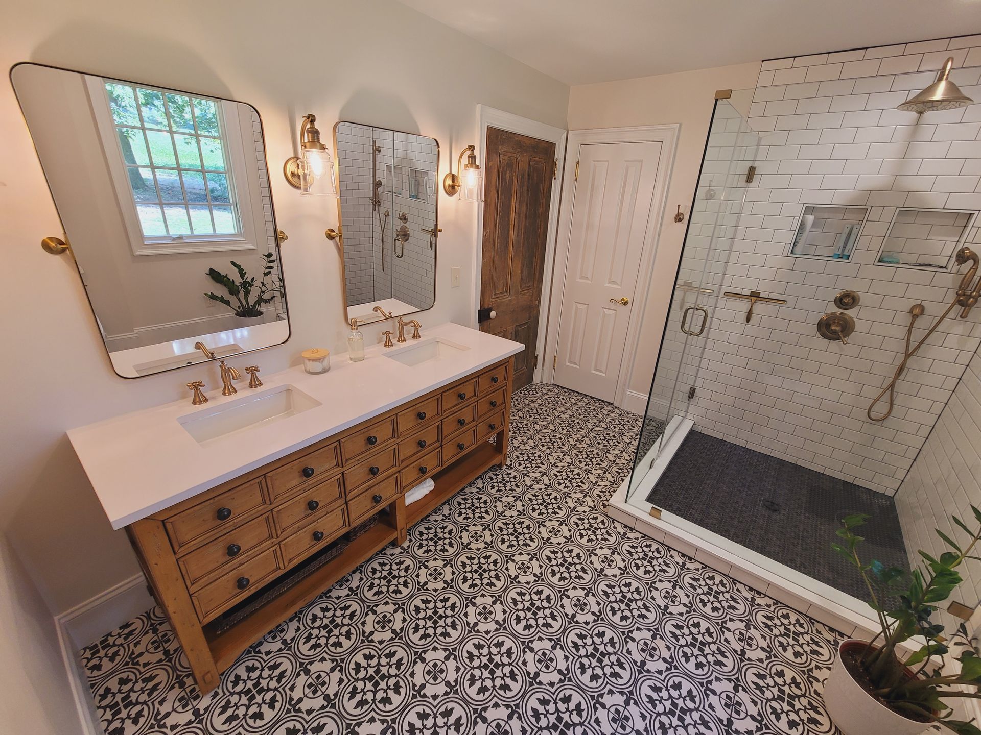 A bathroom with purple walls , a sink , toilet and shower.