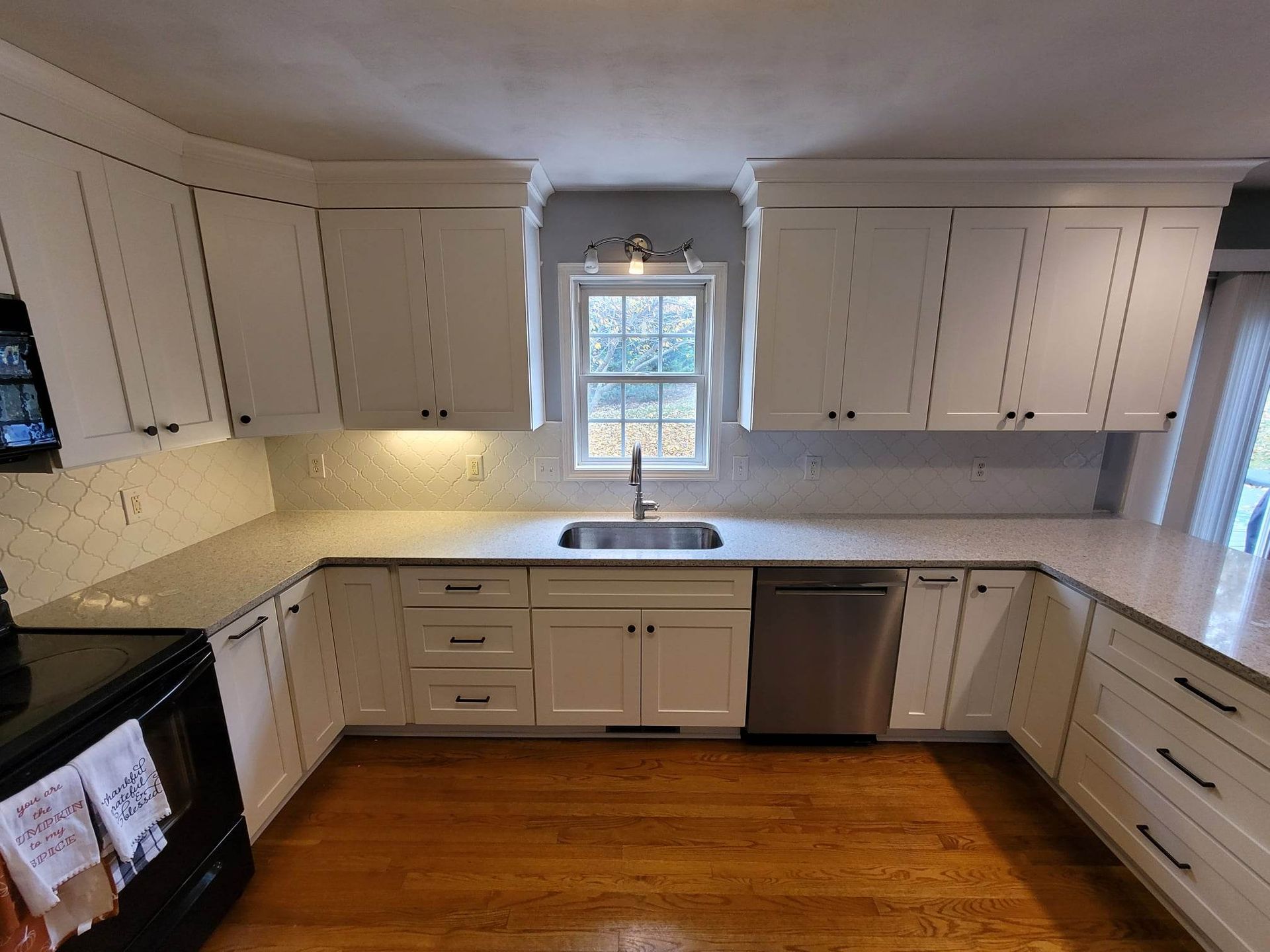 A kitchen with white cabinets and stainless steel appliances