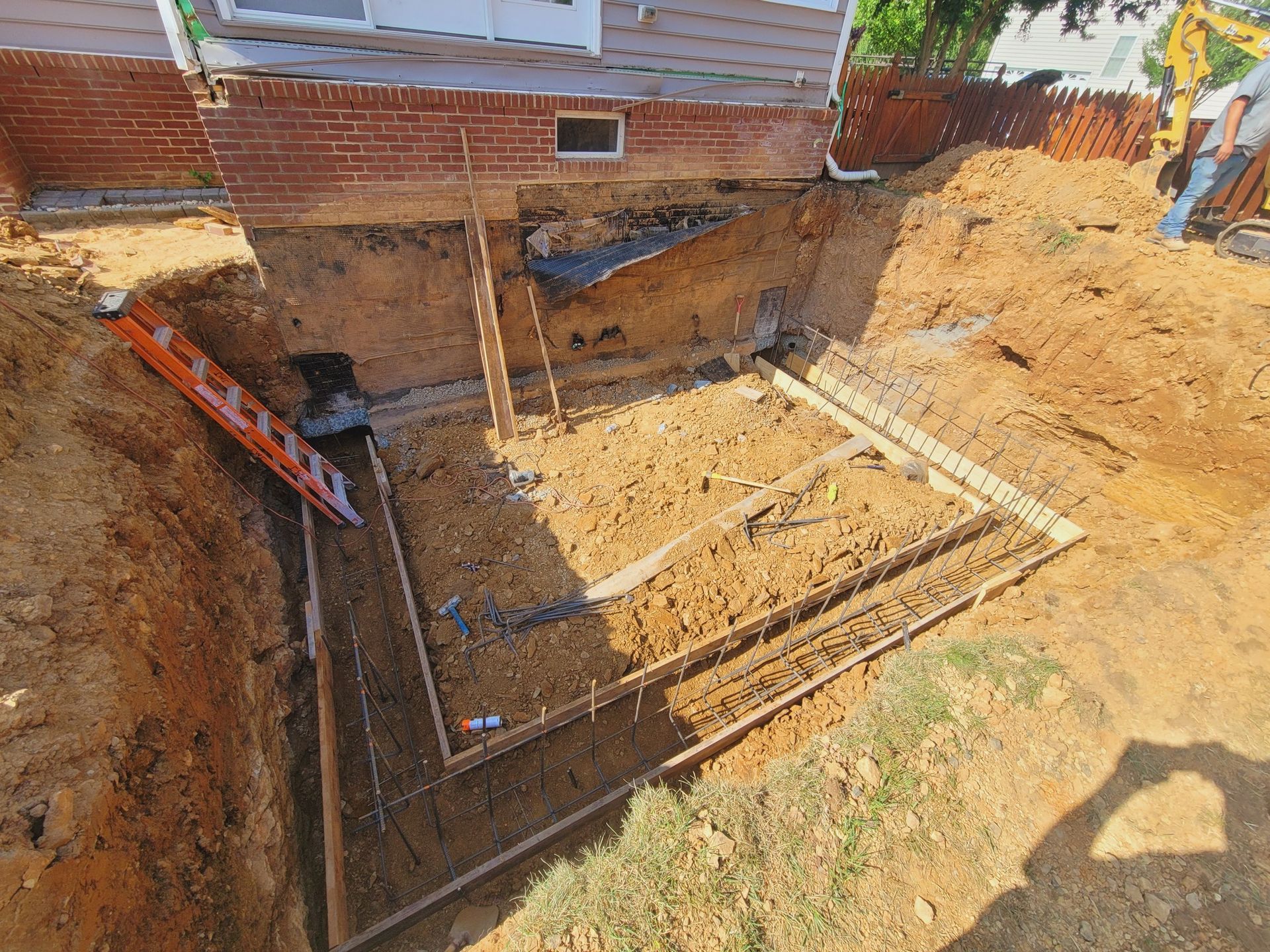 An aerial view of a construction site with a ladder in the dirt.