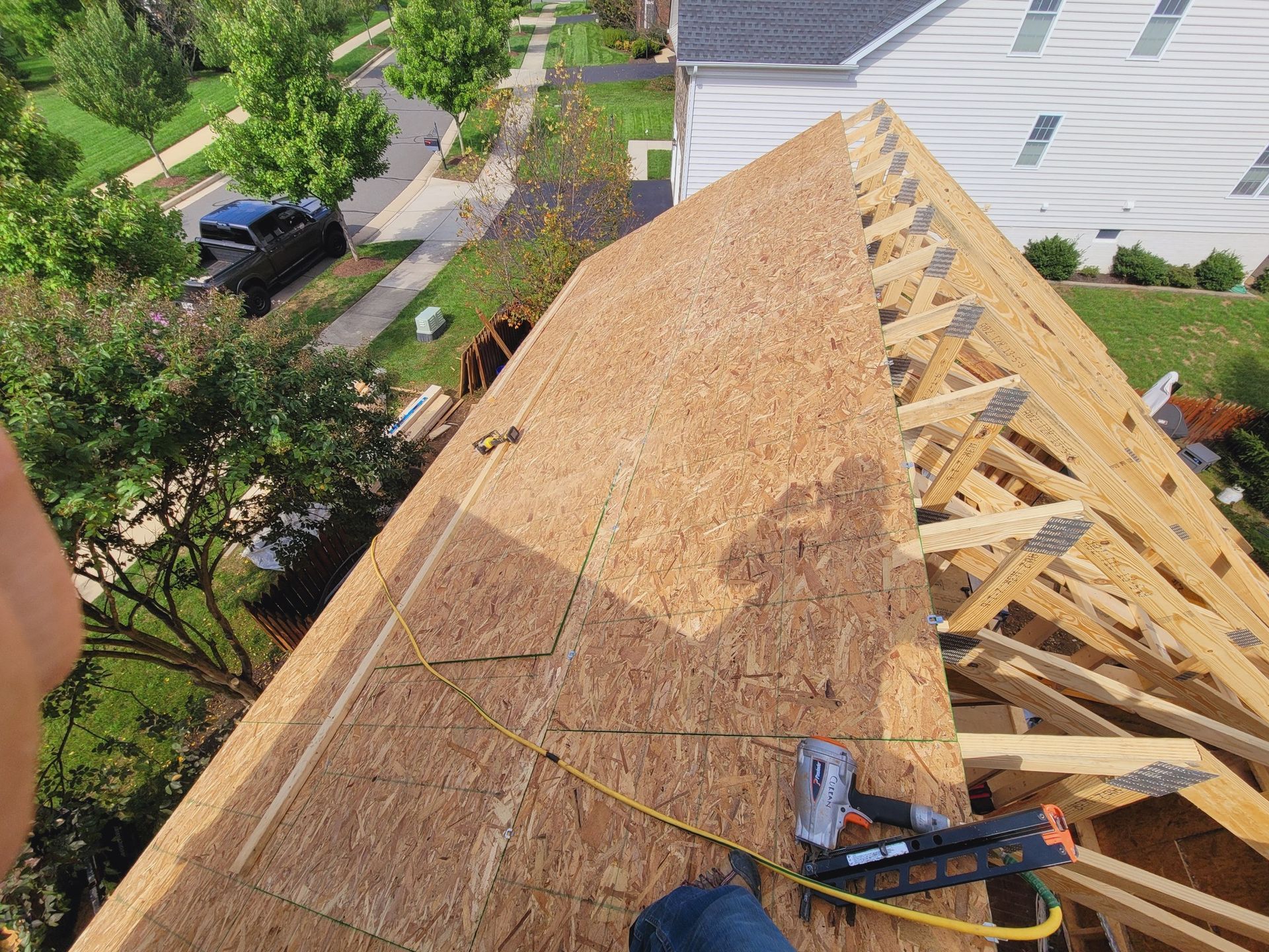 A person is working on the roof of a house.