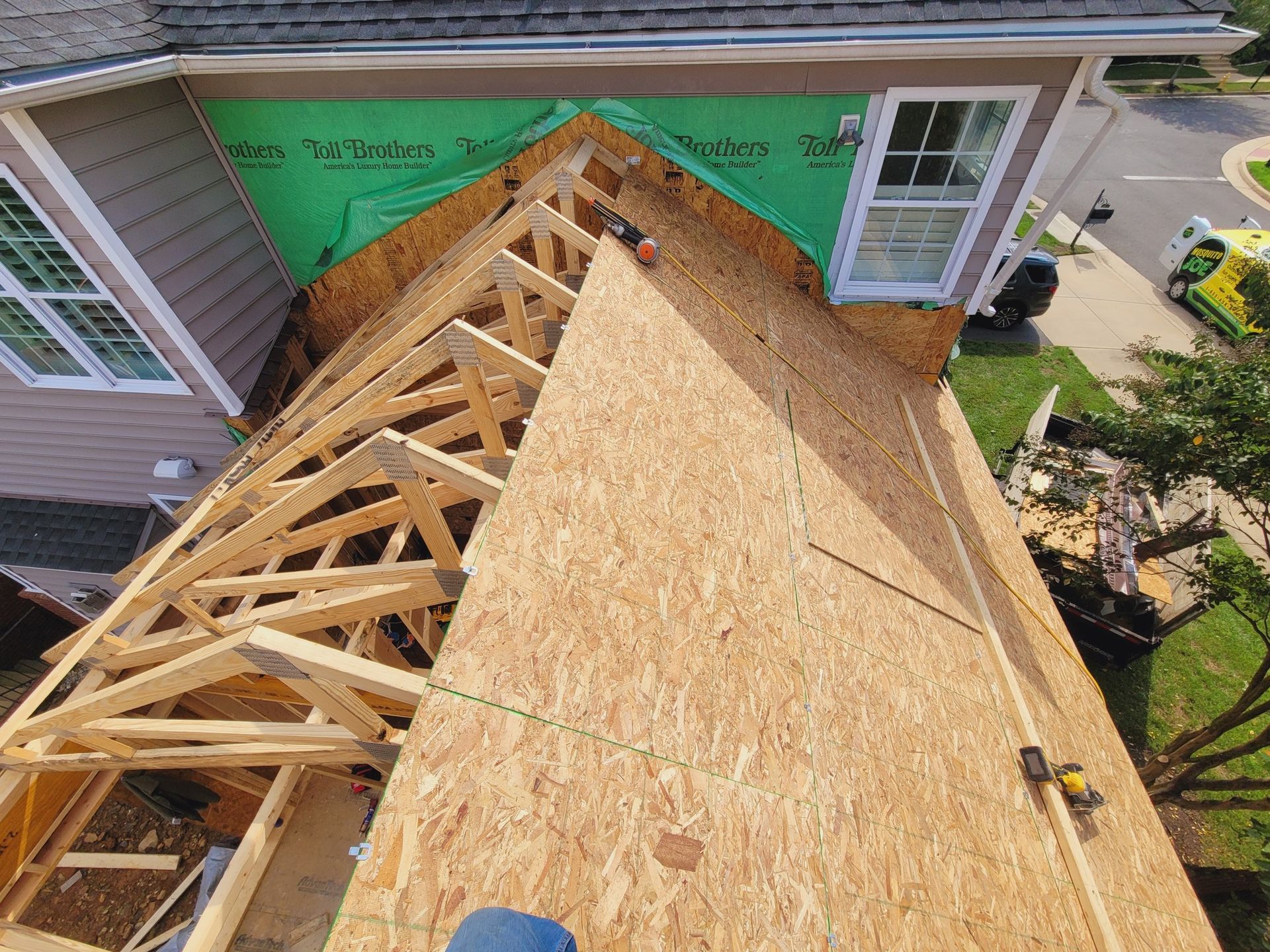 An aerial view of a house under construction with a wooden roof.