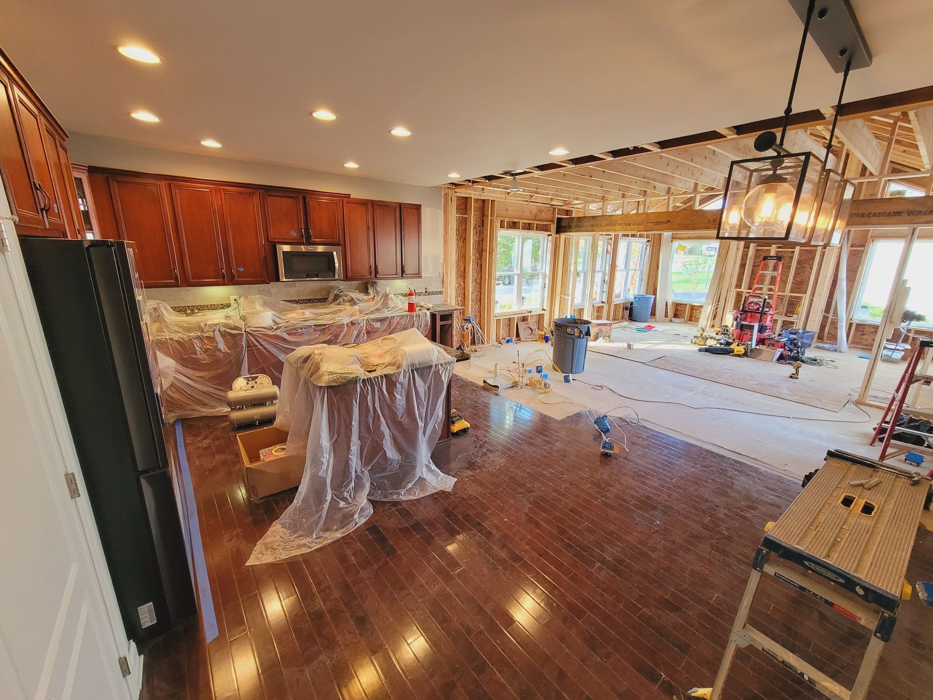 A kitchen and living room are being remodeled in a house.