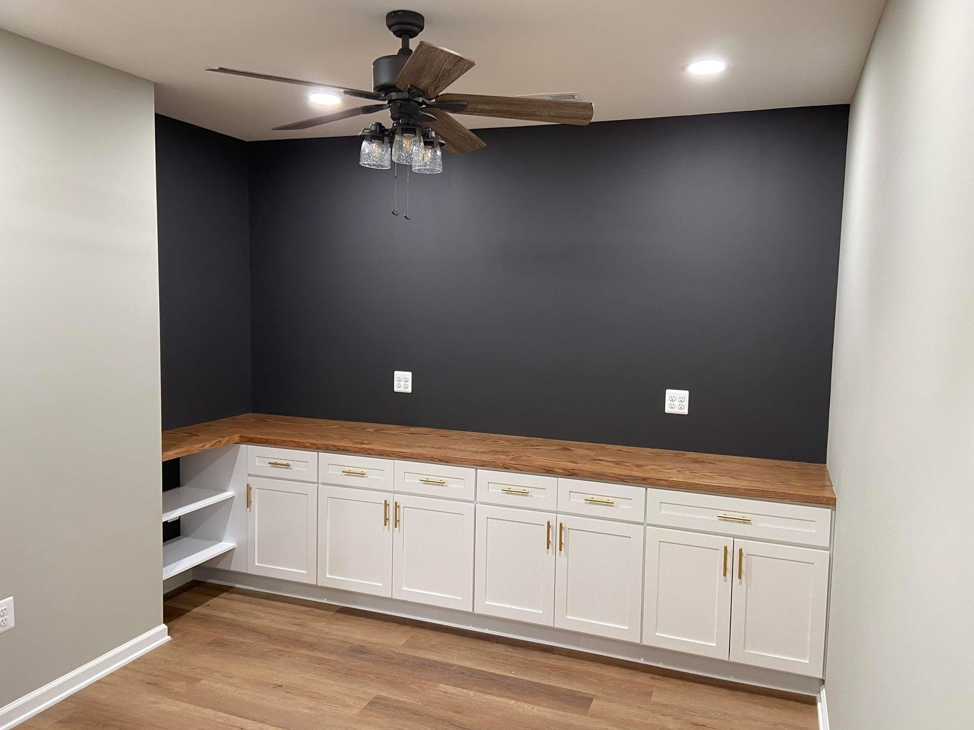 There is a ceiling fan in the corner of the room.