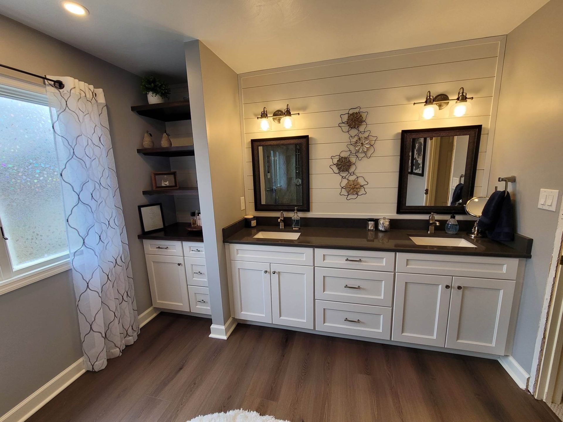 A bathroom with two sinks and two mirrors.