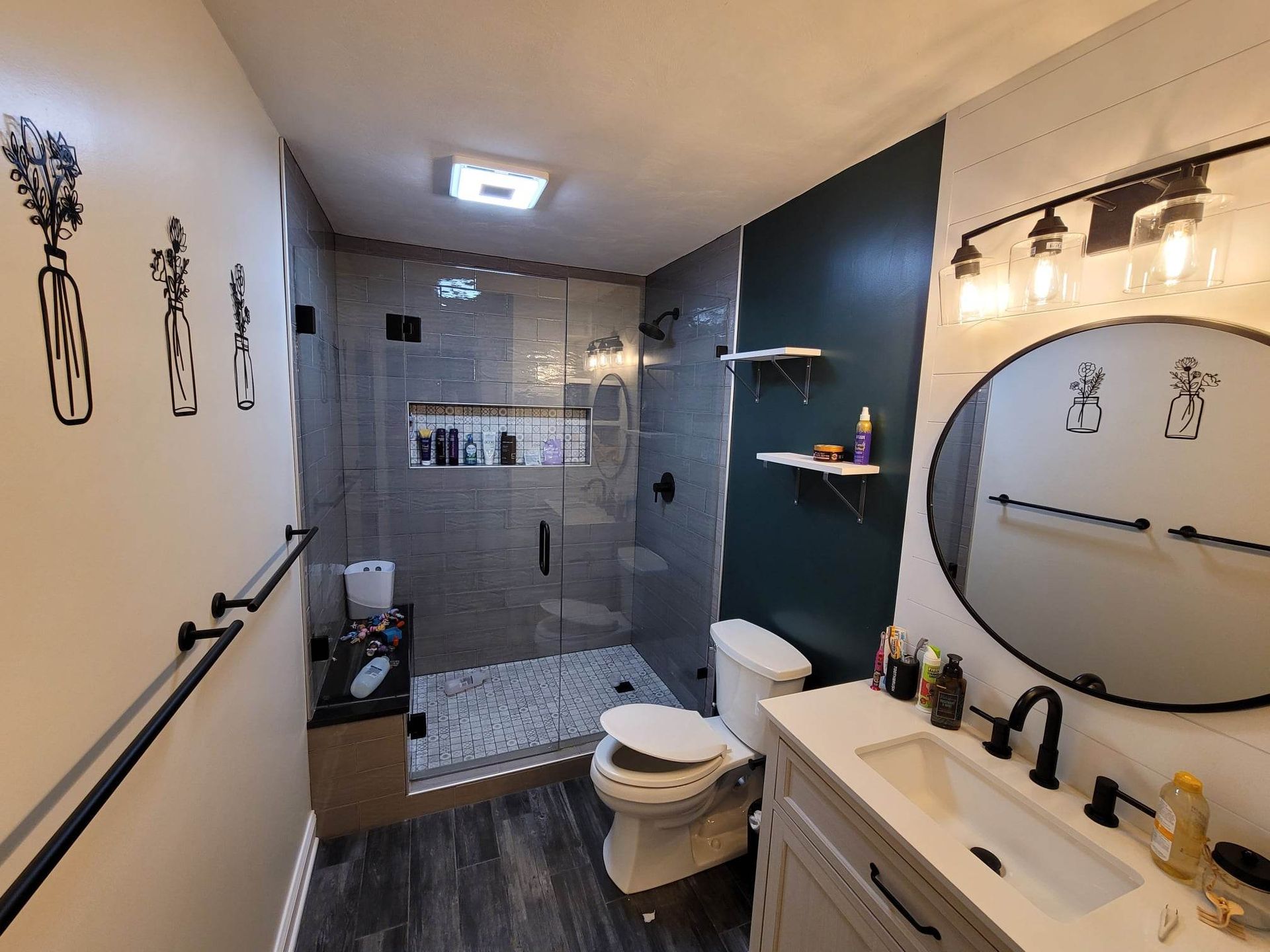 A bathroom with a toilet , sink , and shower.