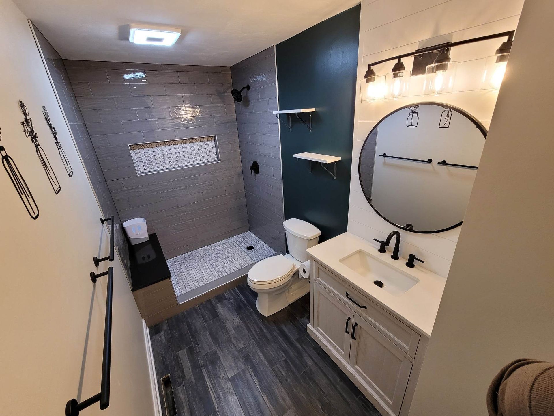 A bathroom with a toilet , sink , and shower.