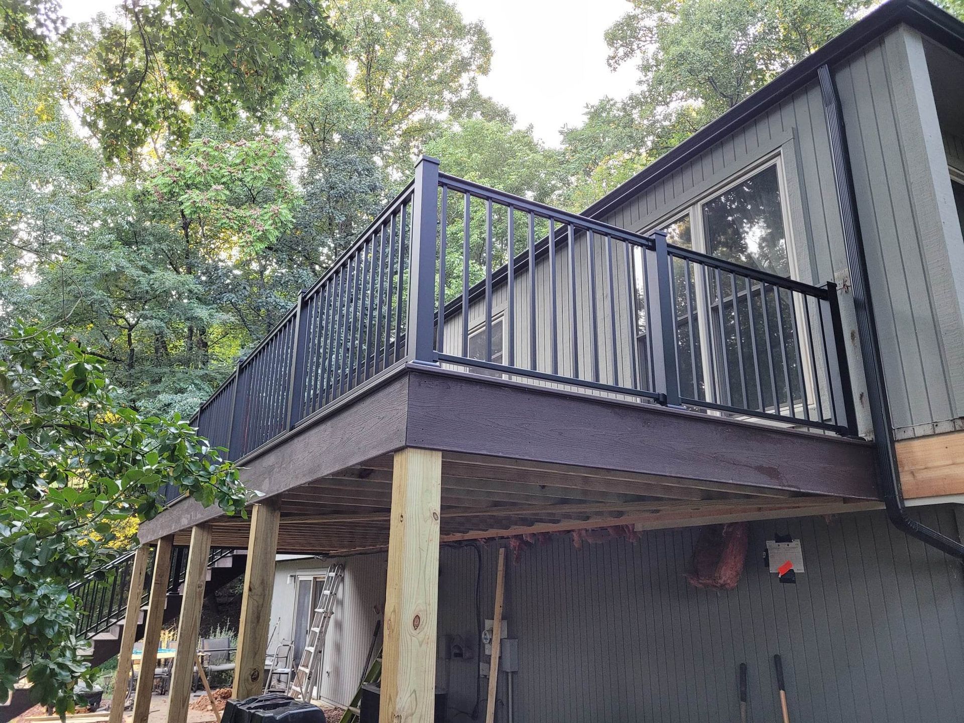 A large deck is being built on the side of a house.