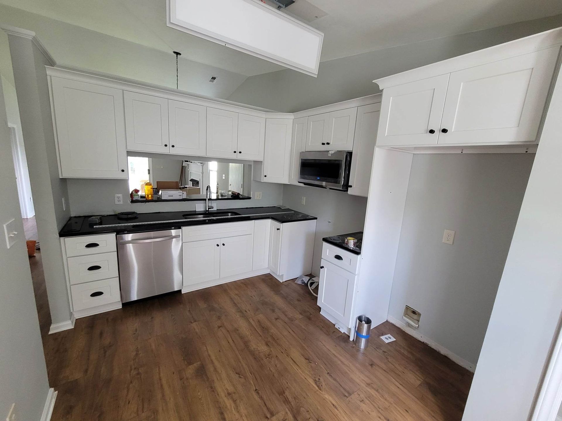 A kitchen with white cabinets and stainless steel appliances.