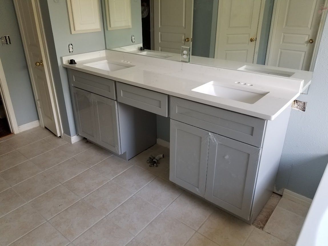 A bathroom with two sinks and a large mirror.