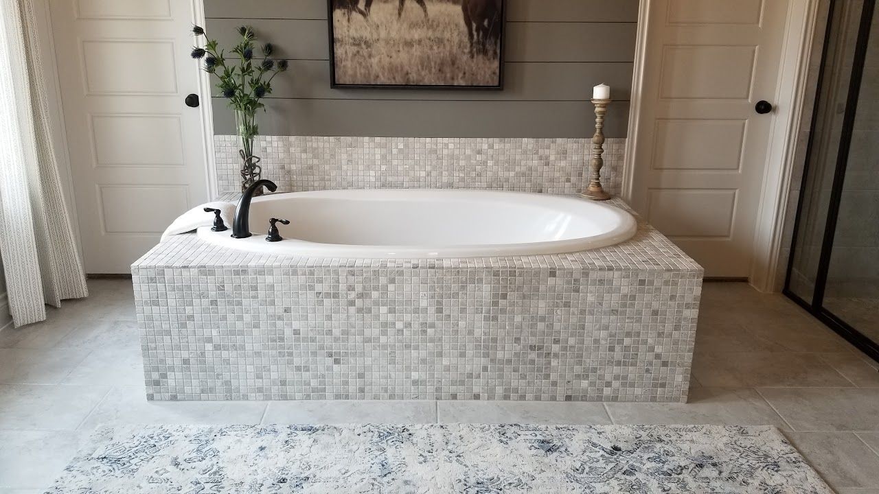 There is a bathtub in the middle of the bathroom.
