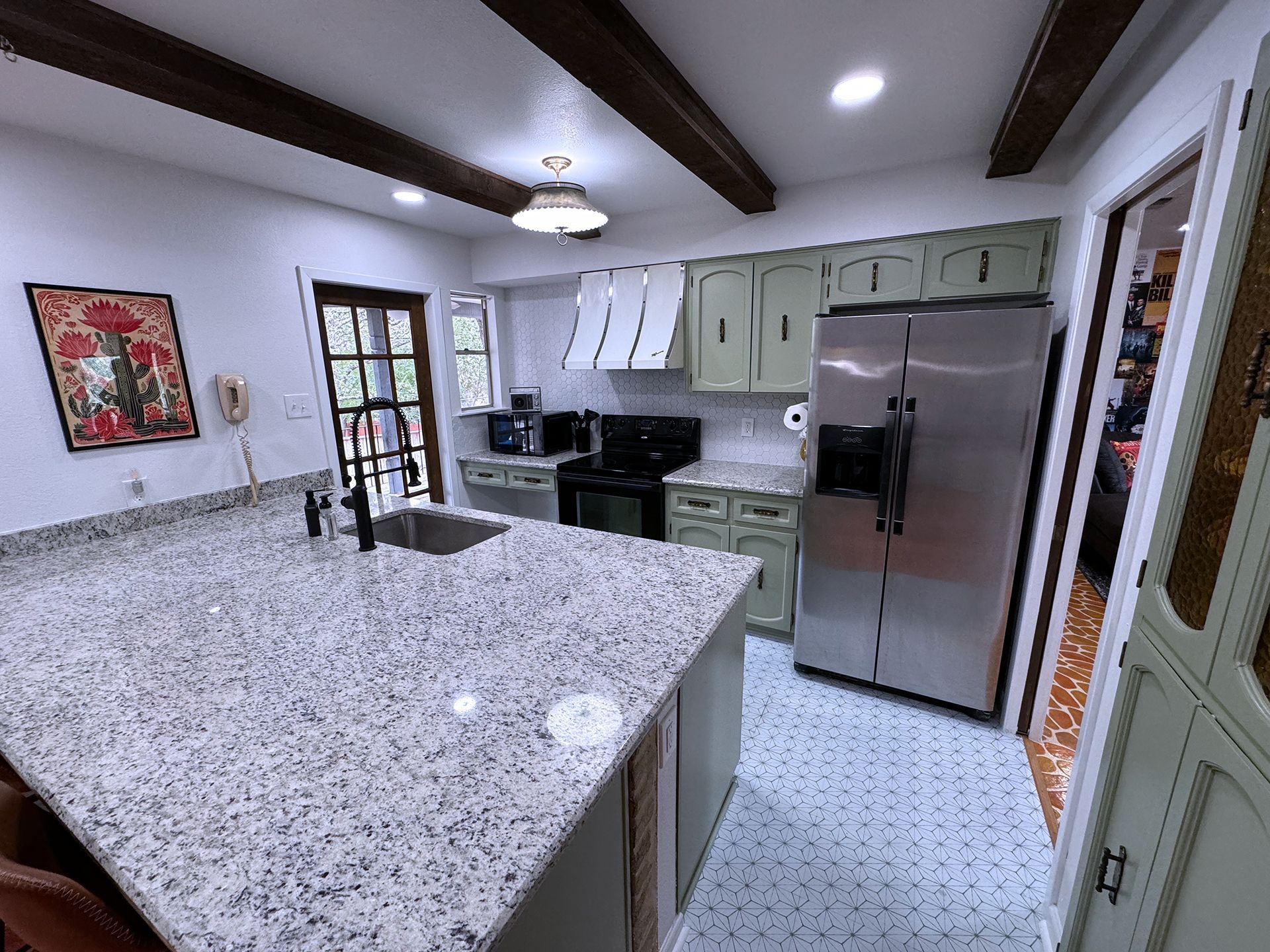 A kitchen with granite counter tops and stainless steel appliances