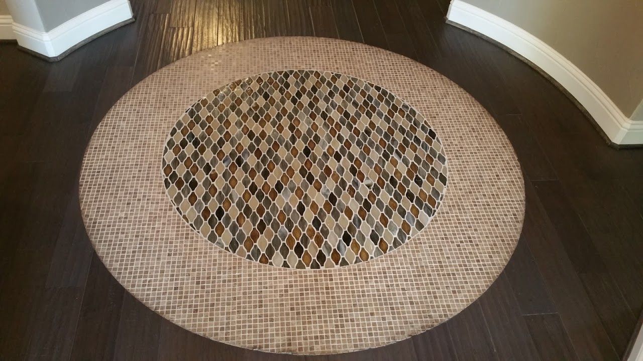 A round rug is on the floor in a room