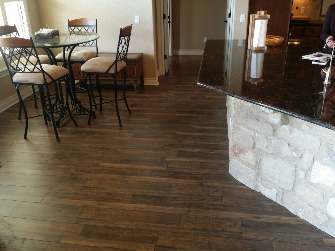 A kitchen with a table and chairs and a granite counter top