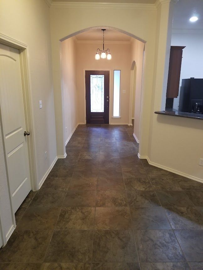 A hallway leading to a kitchen and dining room in a house