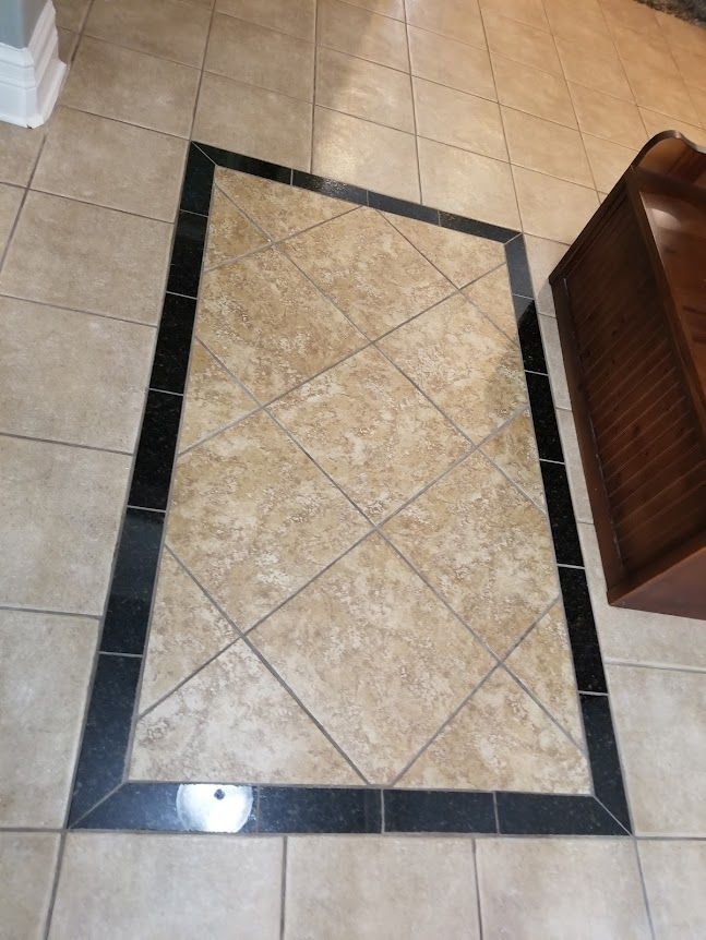 A tiled floor with a black border