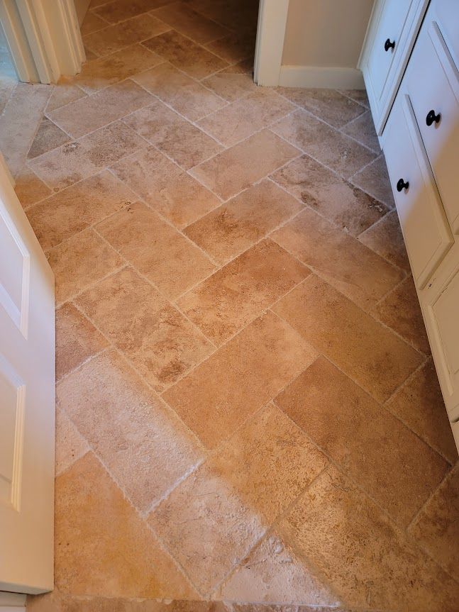 Room with a tiled floor and white cabinets