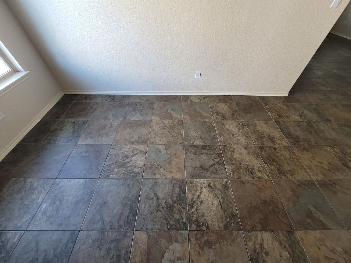 A room with a tiled floor and a white wall