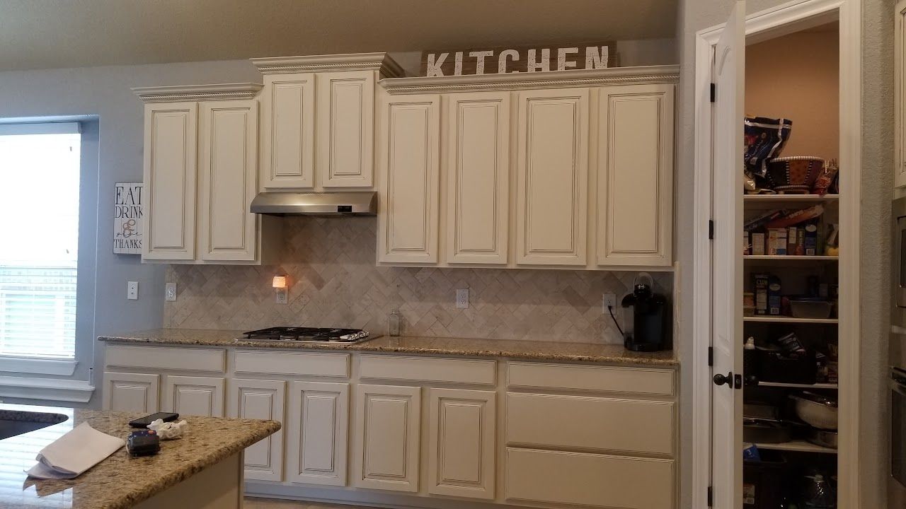 A kitchen with white cabinets and a sign that says kitchen