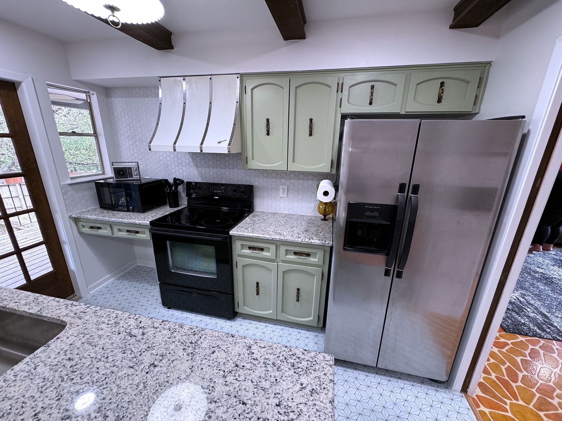 Kitchen with white wall tiles