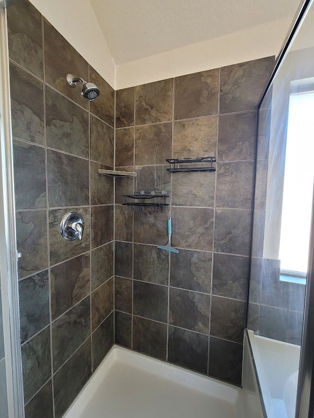 A bathroom with a walk-in shower and a bathtub