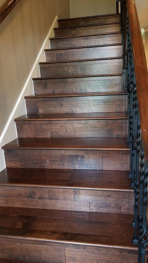 Wooden stairs with a metal railing in a house