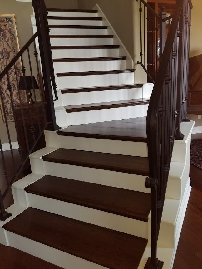 A wooden staircase with white and brown paint