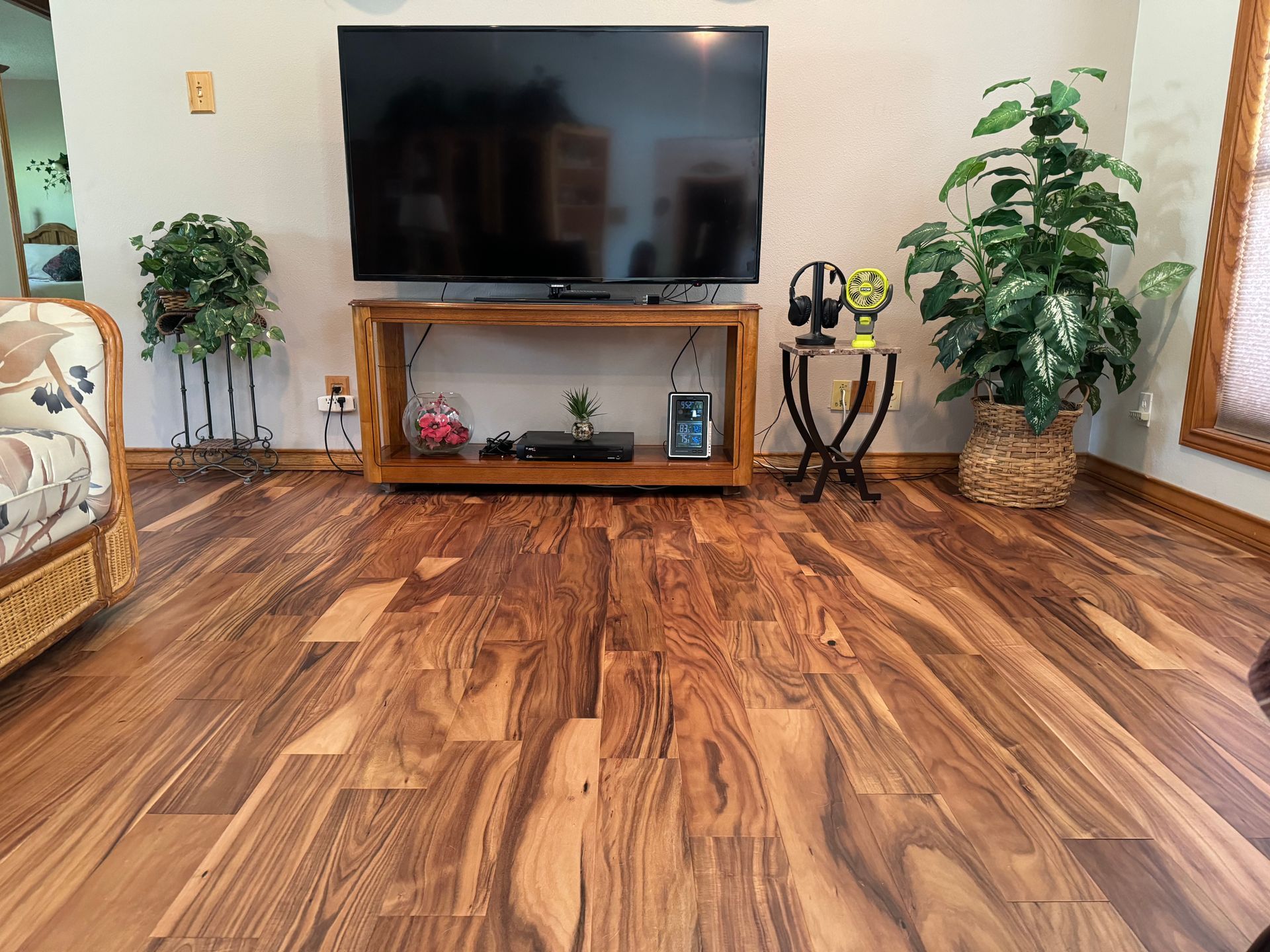 A living room with hardwood floors and a flat screen tv.