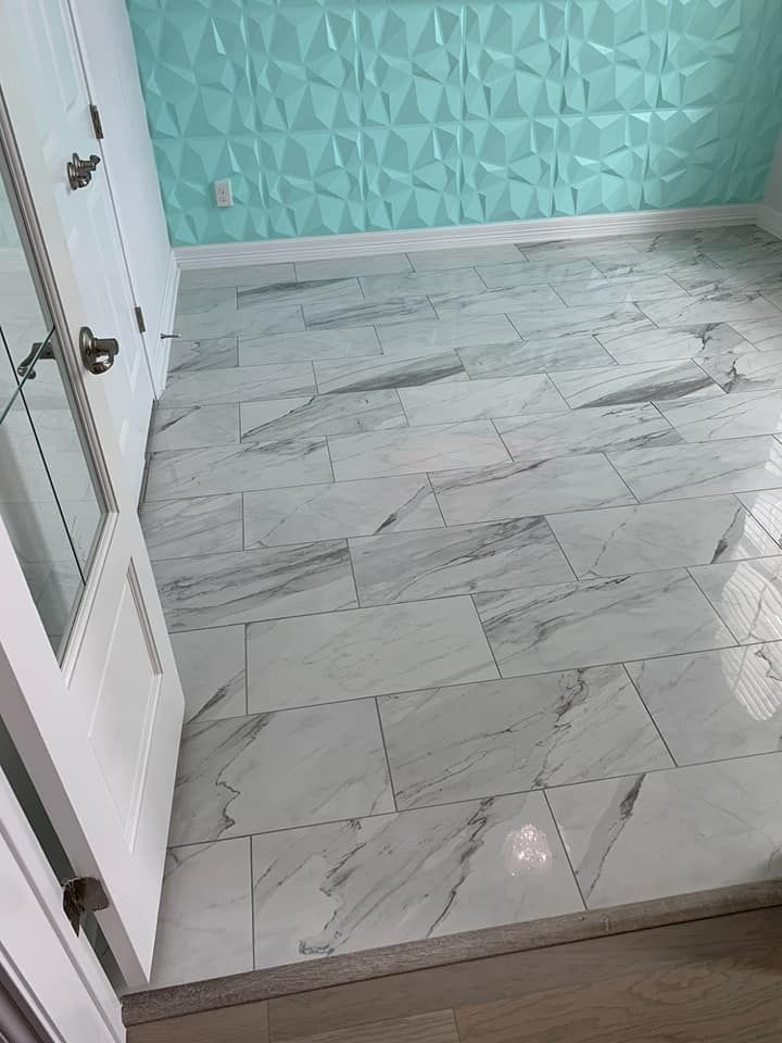 A room with a marble floor and a blue wall.